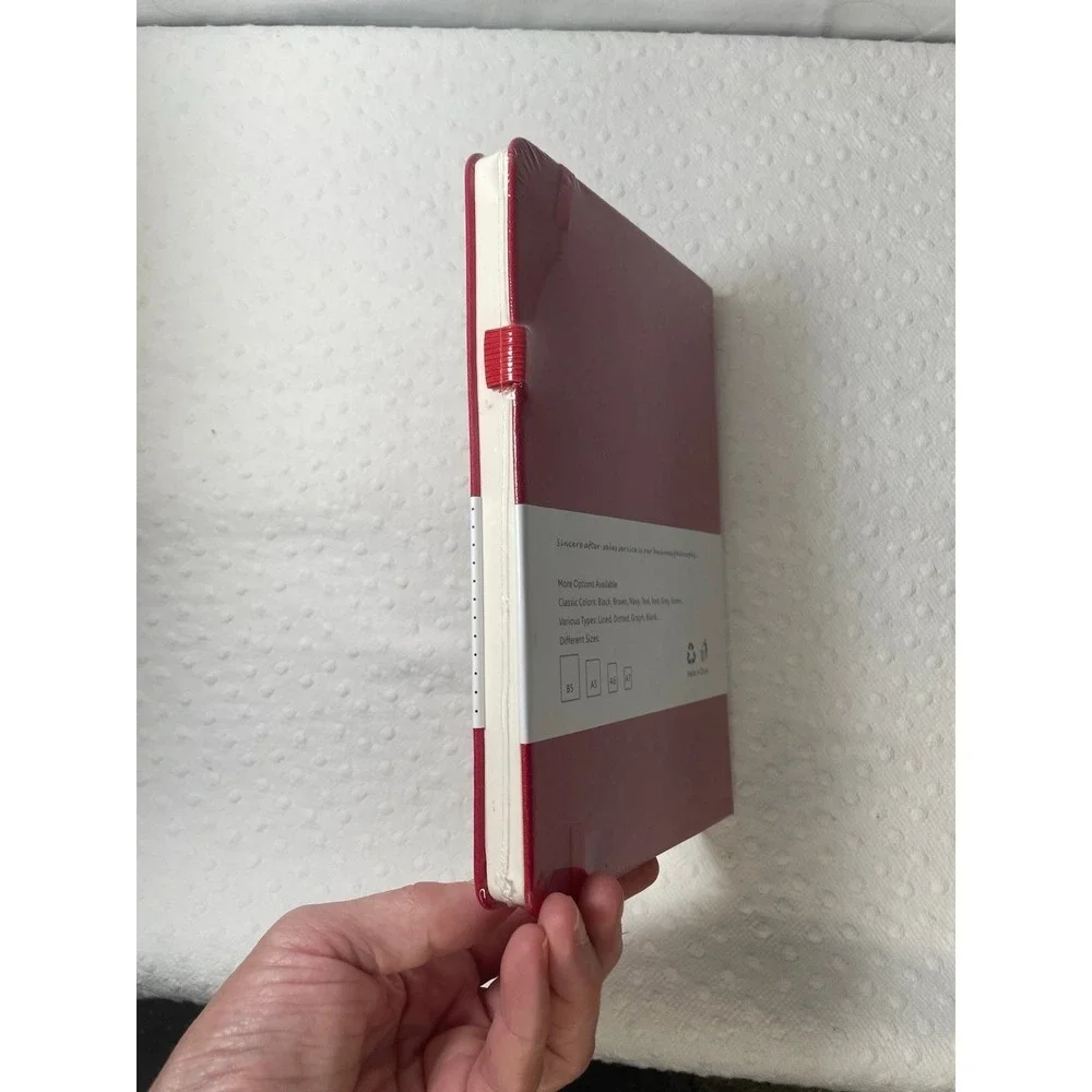 red A5-sized hardcover notebook featuring dotted pages NIP